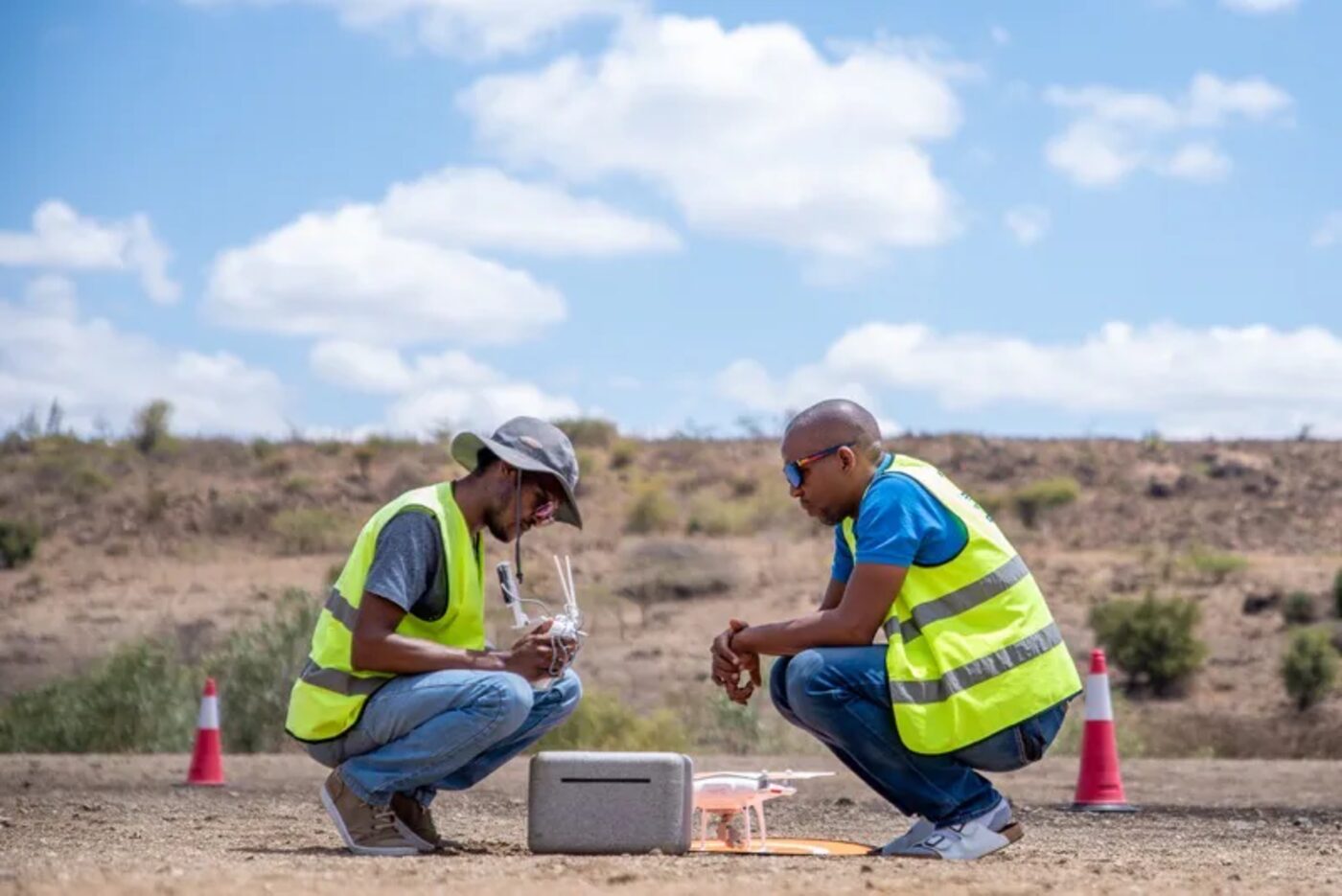 VersaDrones field crew preparing a survey drone at a Kenyan research site
