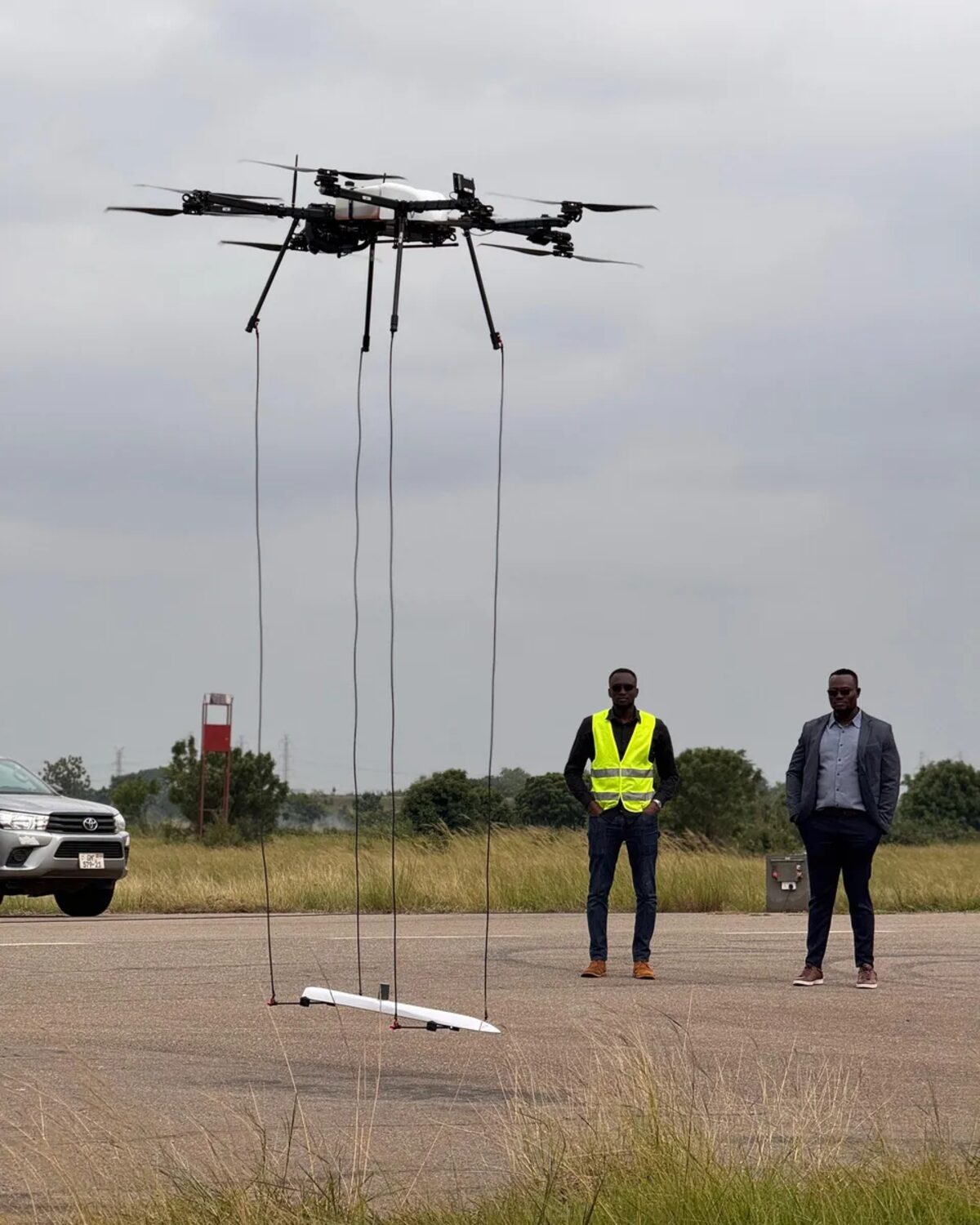 Heavy-lift drone flying a towed sensor array during a geophysical survey